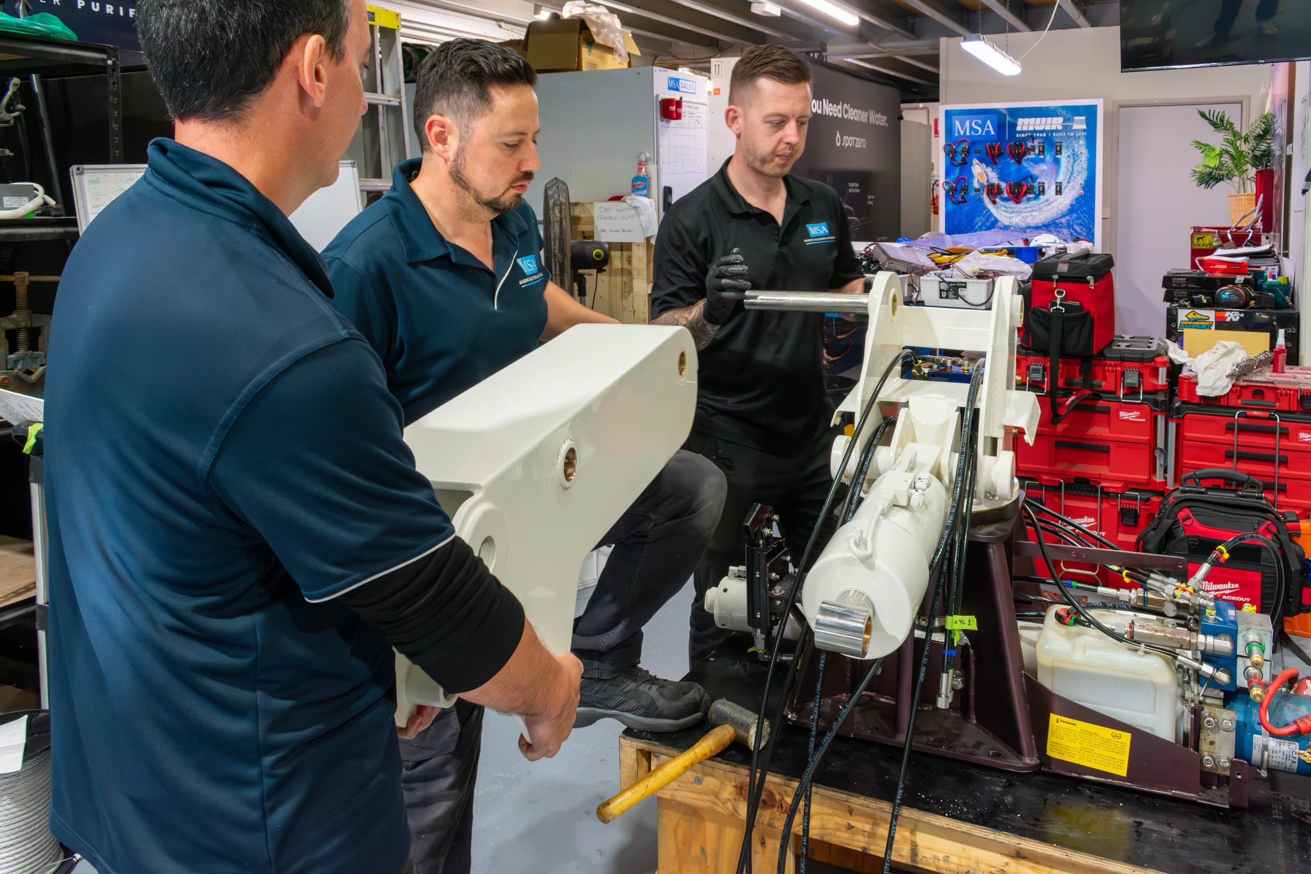 Marine Solutions technicians assembling a rebuilt hydraulic davit crane in the Coomera workshop
