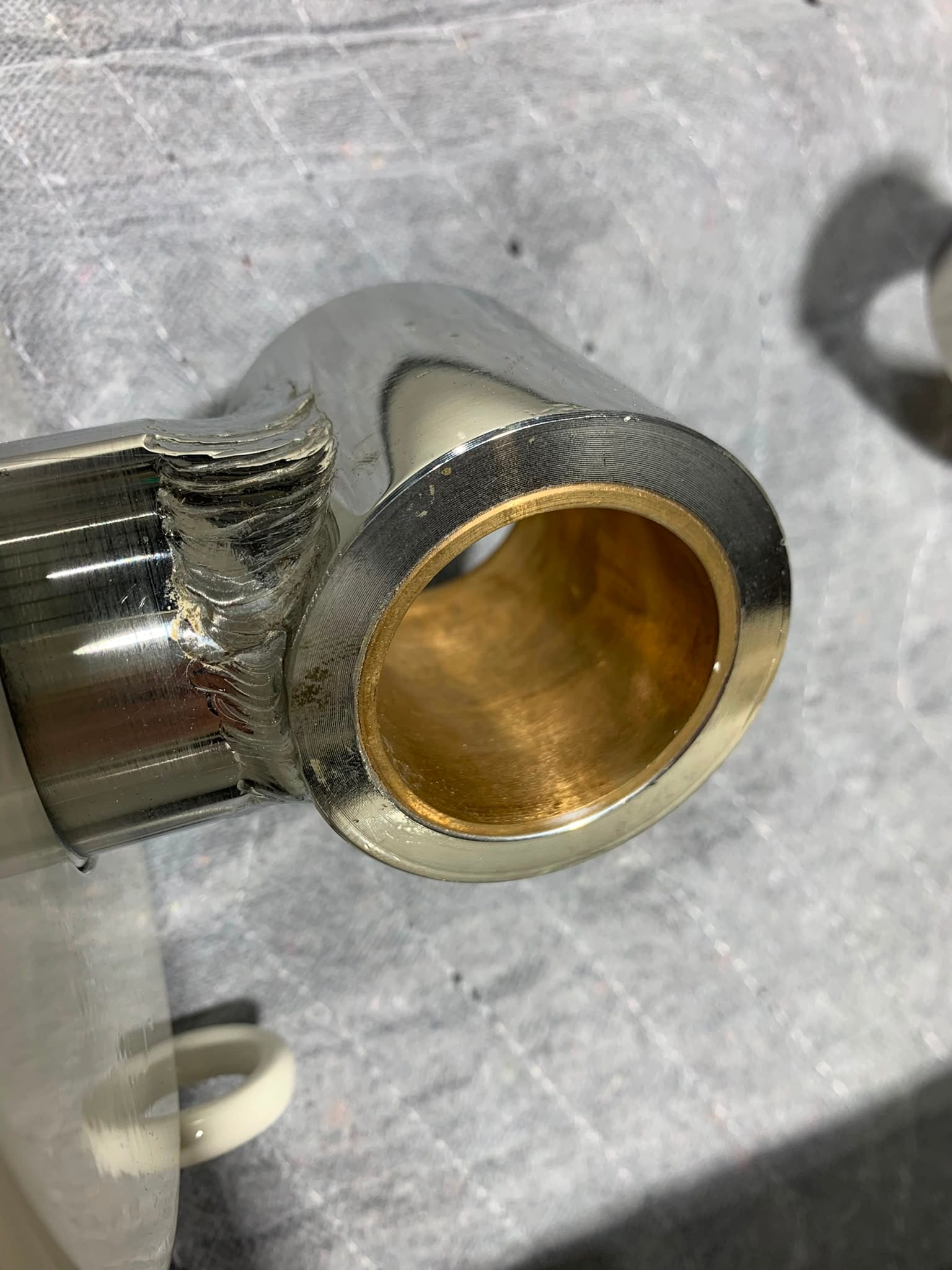 Pin bush cleaned back to bronze after overspray was found in the bores