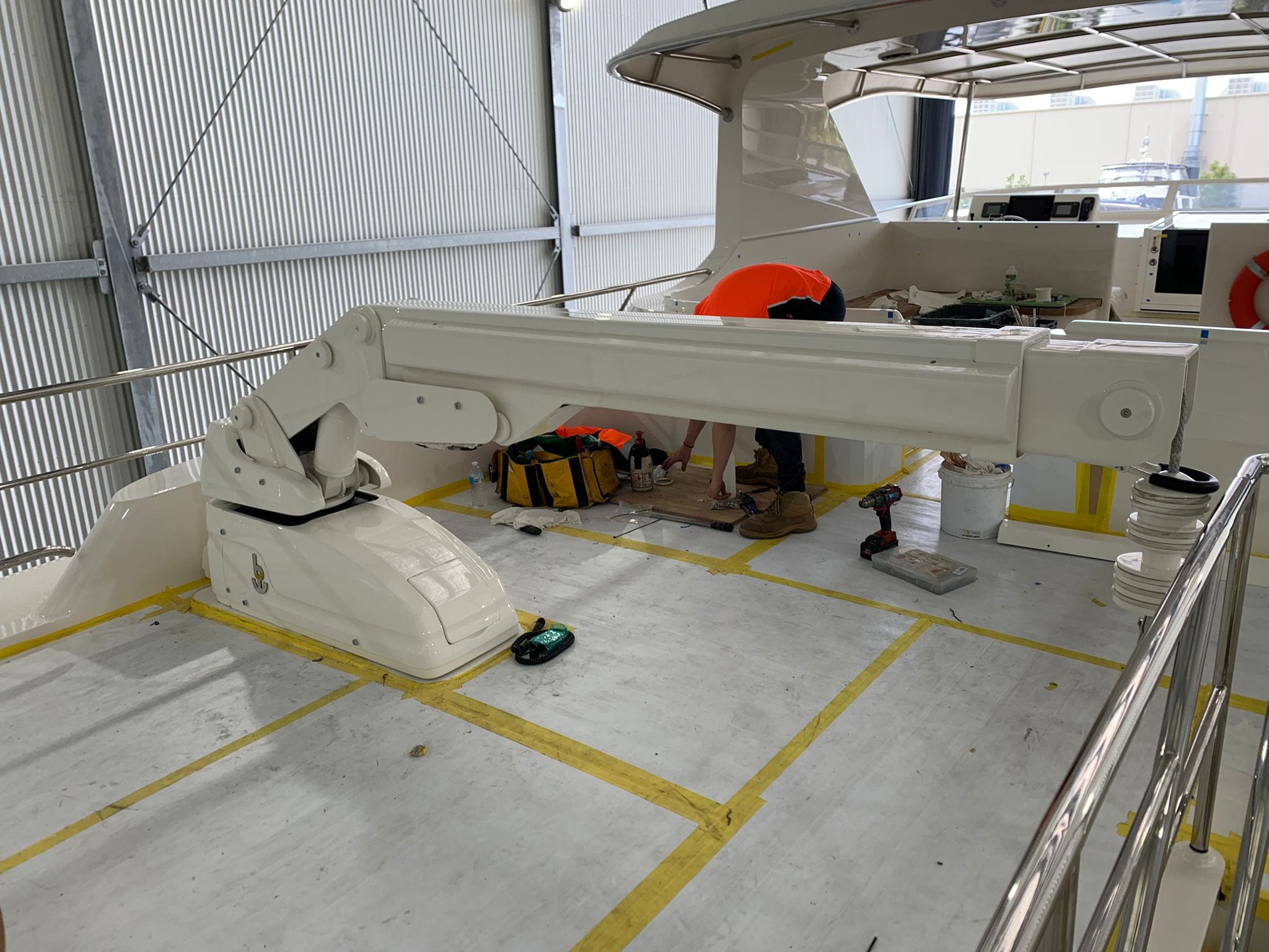 Crane bolted down on the aft deck in the shed at The Boat Works