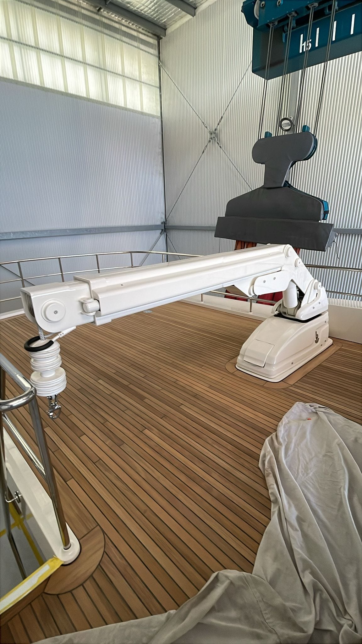 Davit stowed on the teak before the vessel went back in the water
