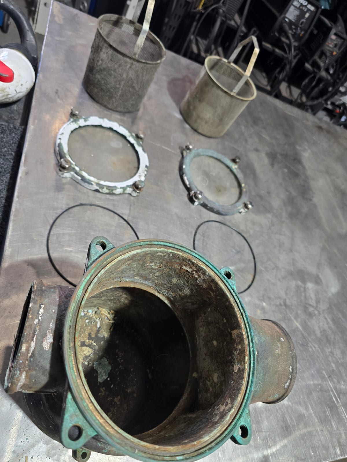 Sea strainer stripped for refurbishment — verdigris through the bronze housing