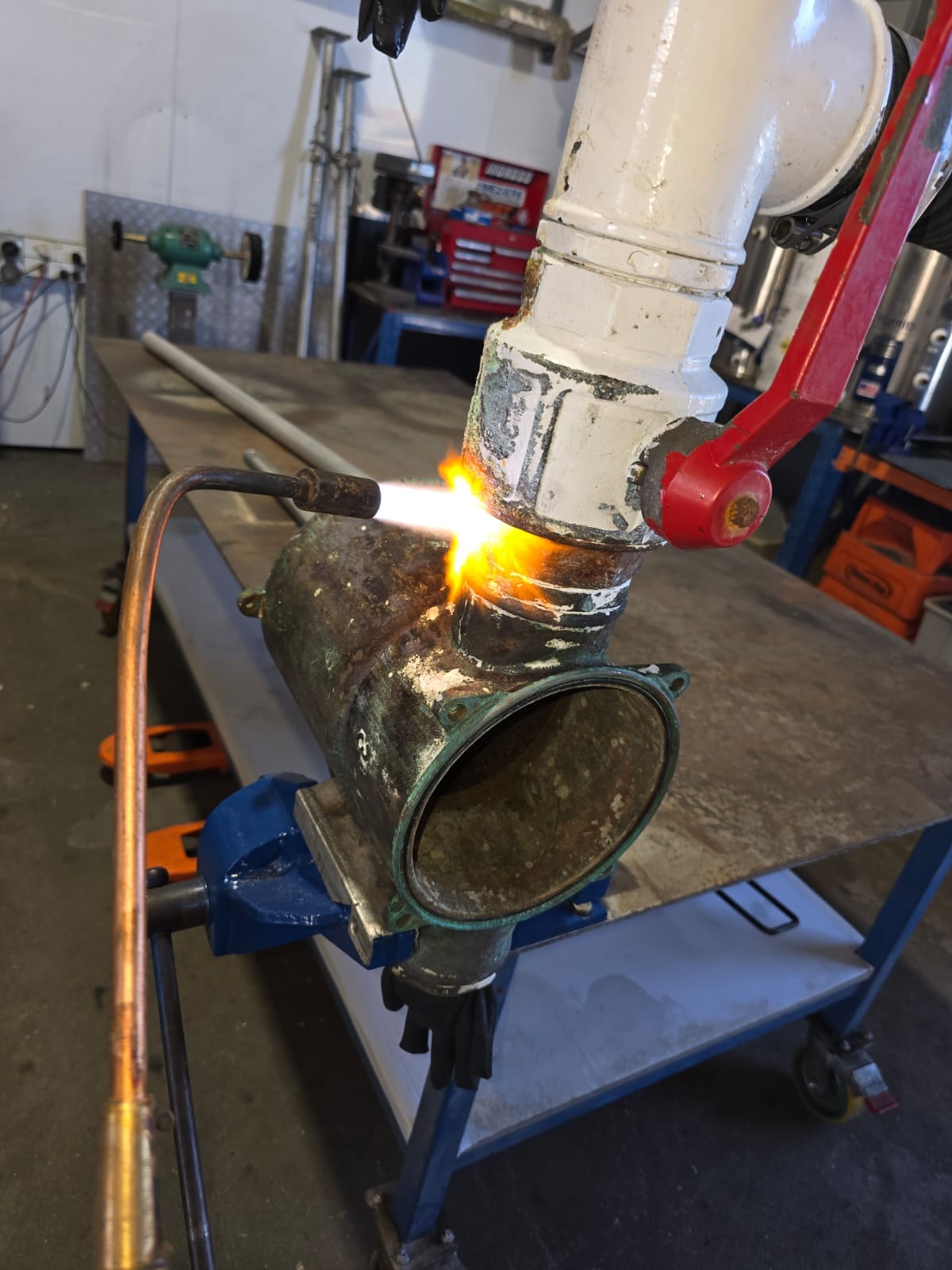 Freeing a seized bronze fitting with the torch in our Coomera workshop