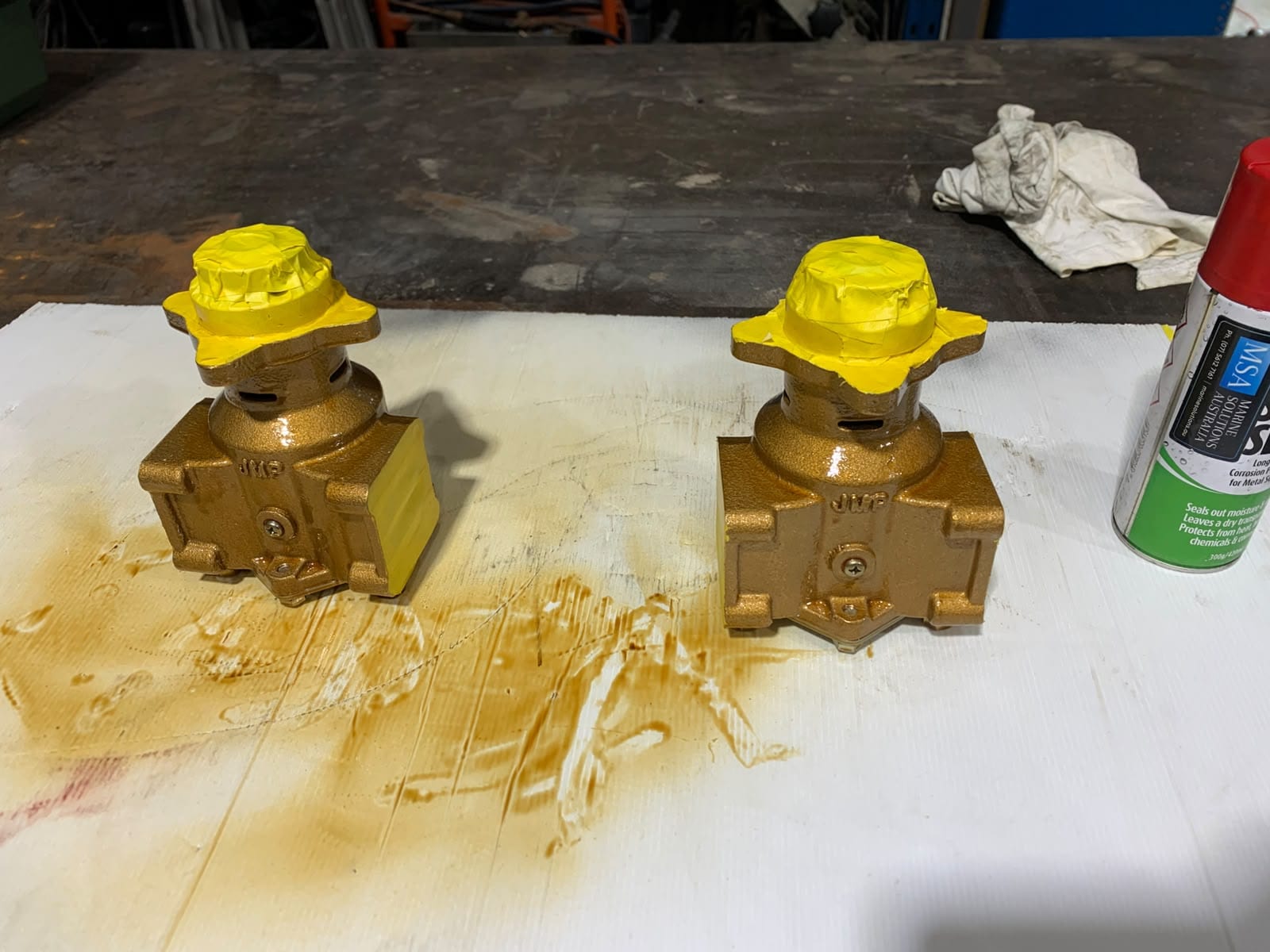 Two new raw water pumps in two coats of Soft Seal on the bench