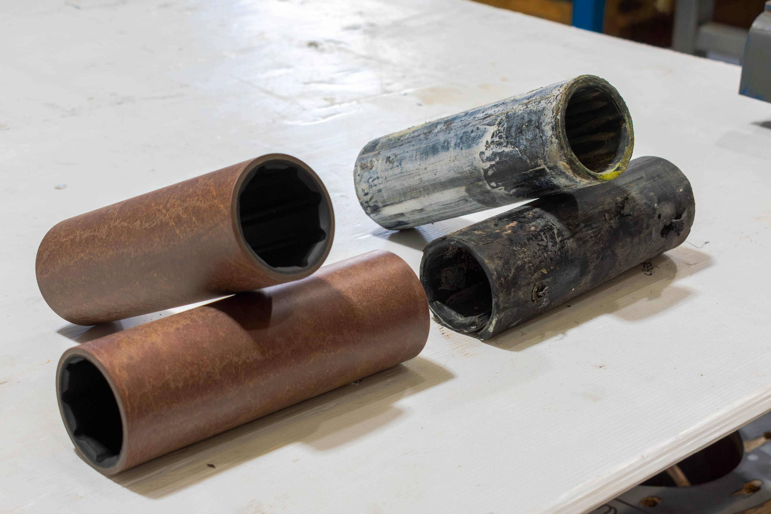 All four old cutlass bearings on the bench, two from the struts and two from the stern tubes