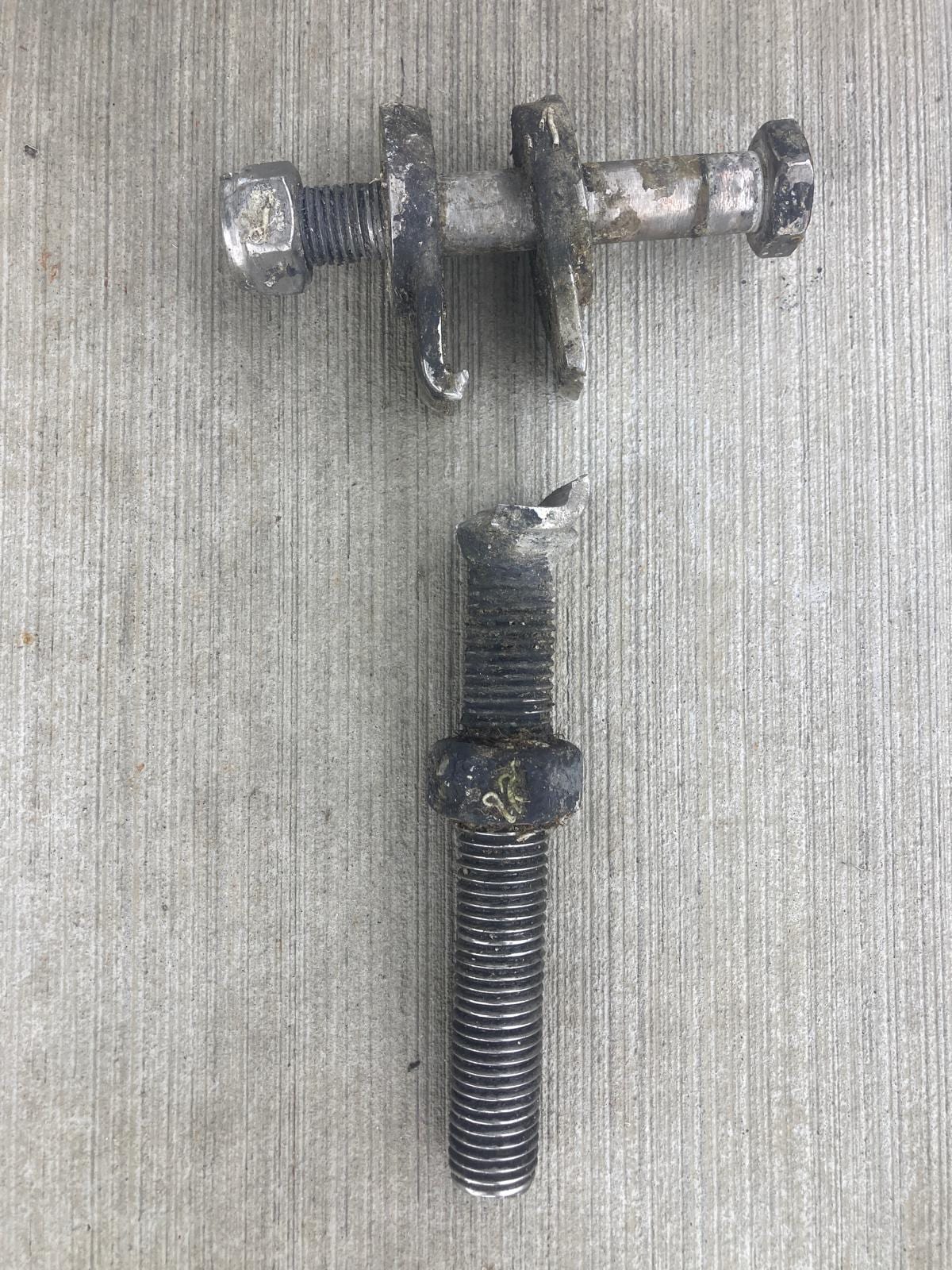 The snapped bottle-screw lifting strut, failed clean through the thread