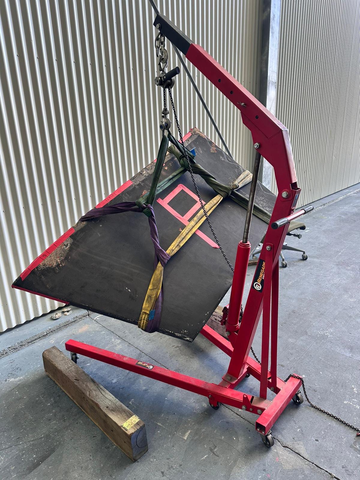 Stabiliser fin slung on the workshop crane after removal