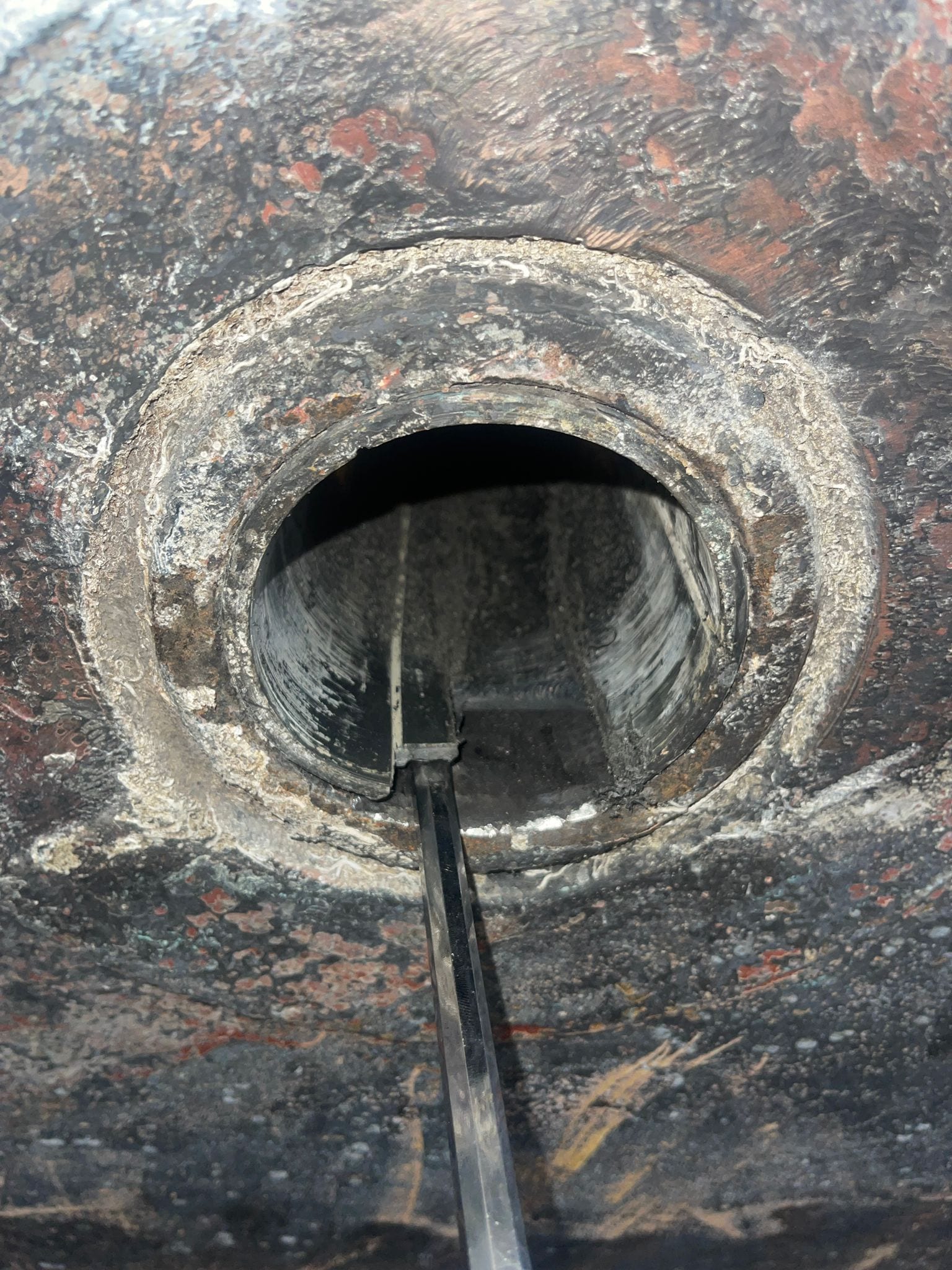 Chiselling the seized composite sleeve bearing out of its housing
