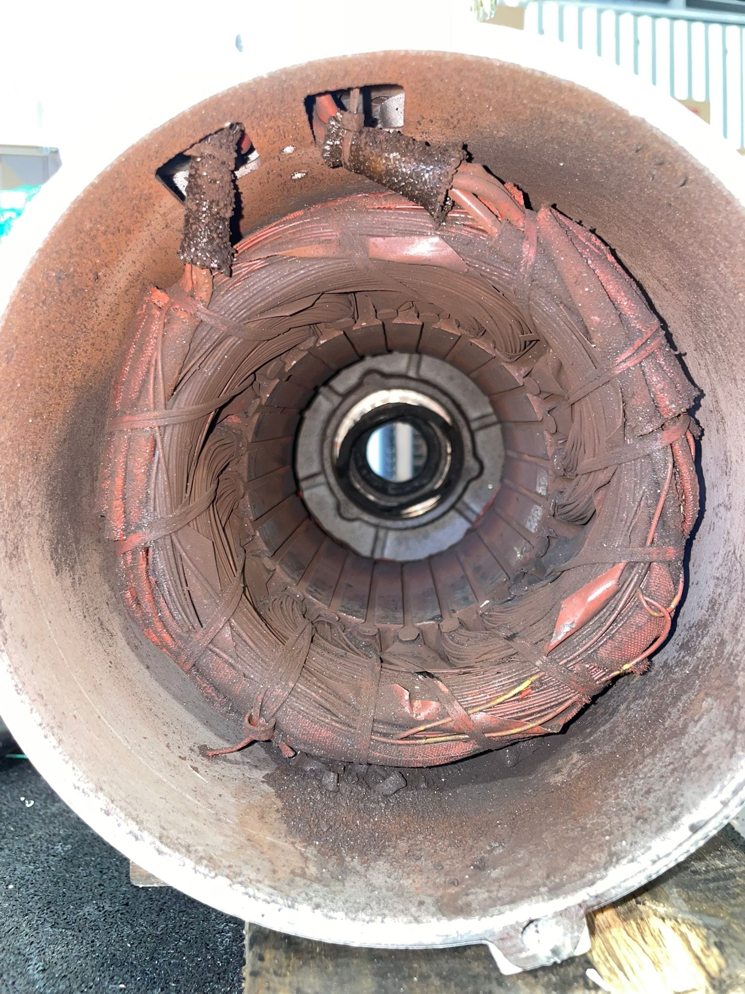 Failed pump motor opened up — debris and corrosion through the stator bore