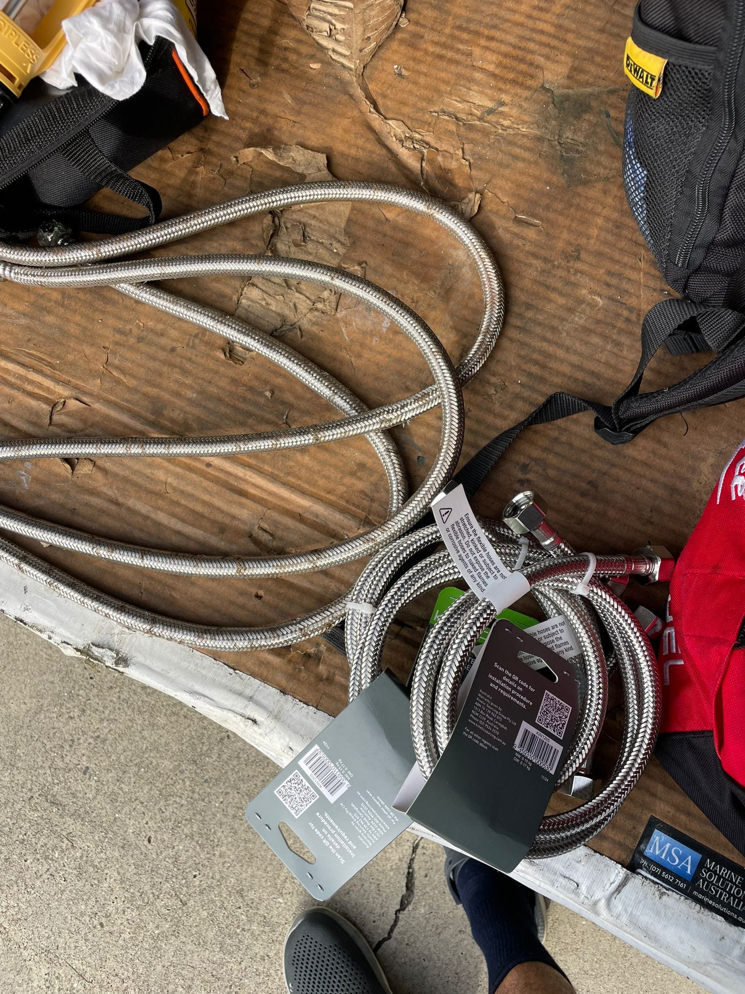 Replacement braided flexible hoses staged for the fresh water system