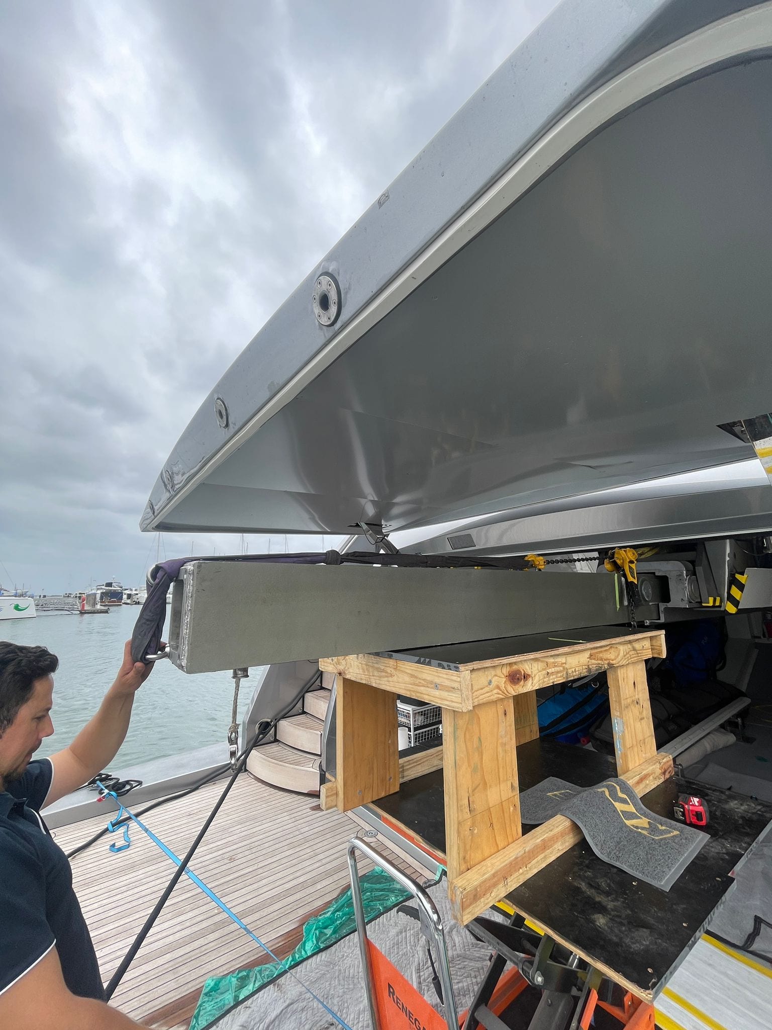 Crane beam walked out on slings and trestles at the berth — no shipyard crane