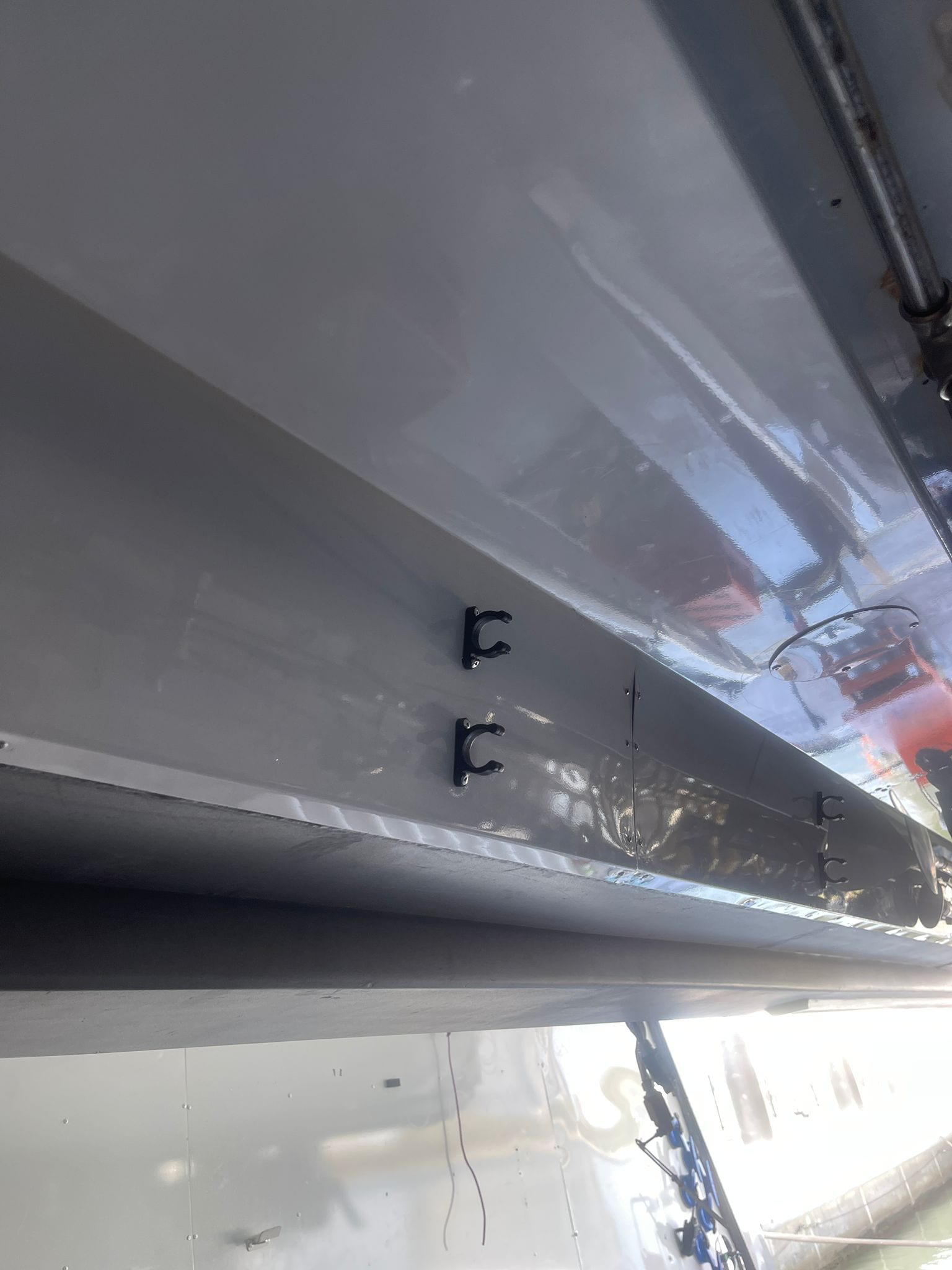 Crane arm underside repainted with rope-retainer clips refitted