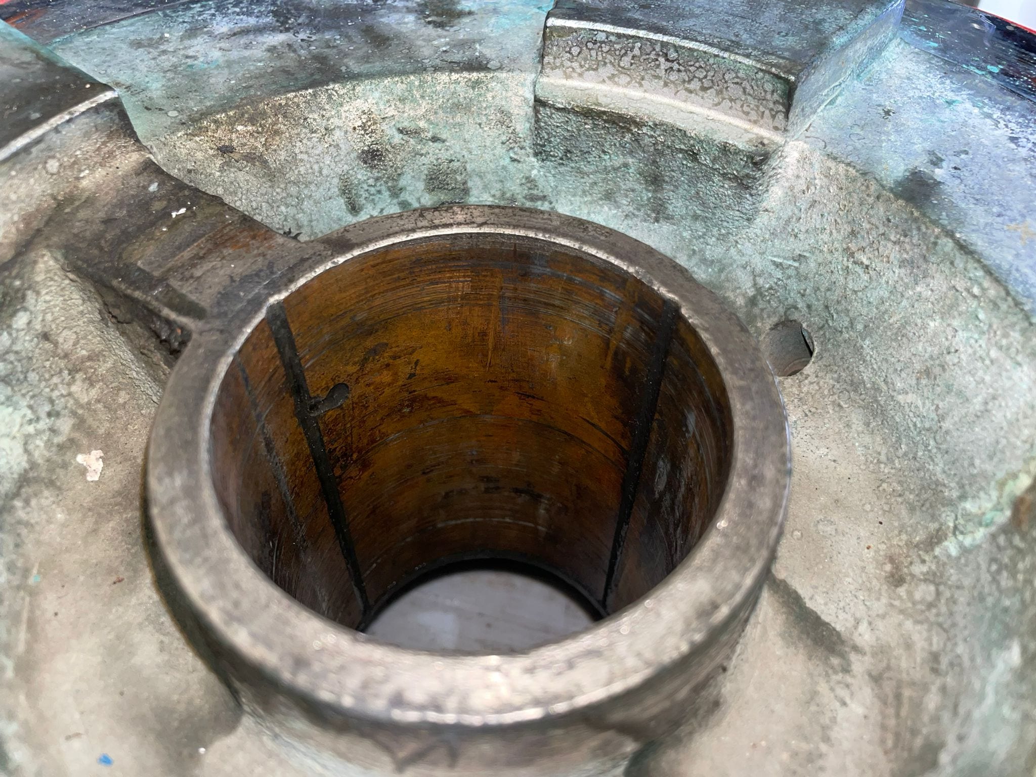 Starboard top gear flange as it came out, verdigris through the casting and the bore stained by sea water