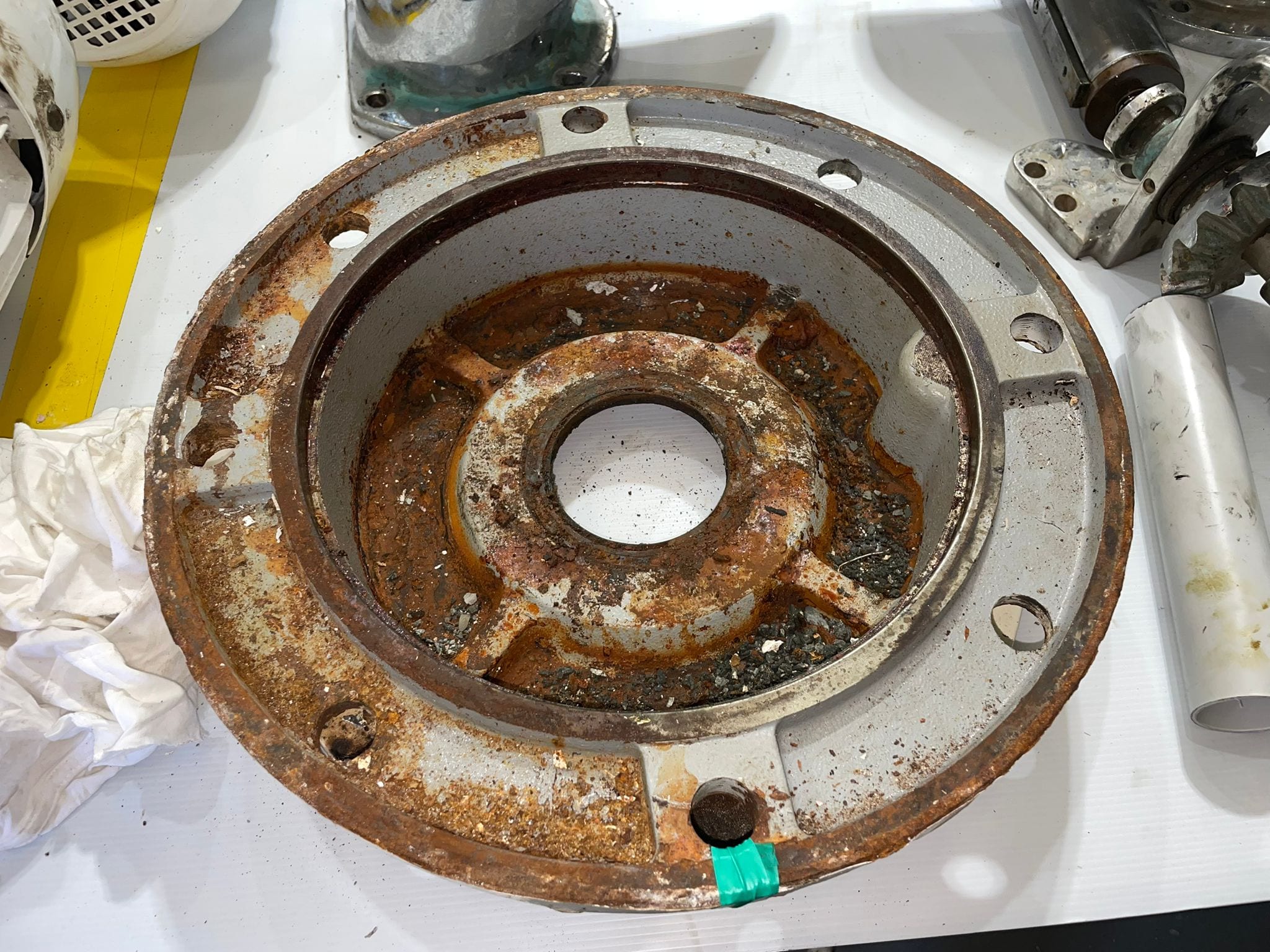 Adaptor plate rusted through its recess before treatment