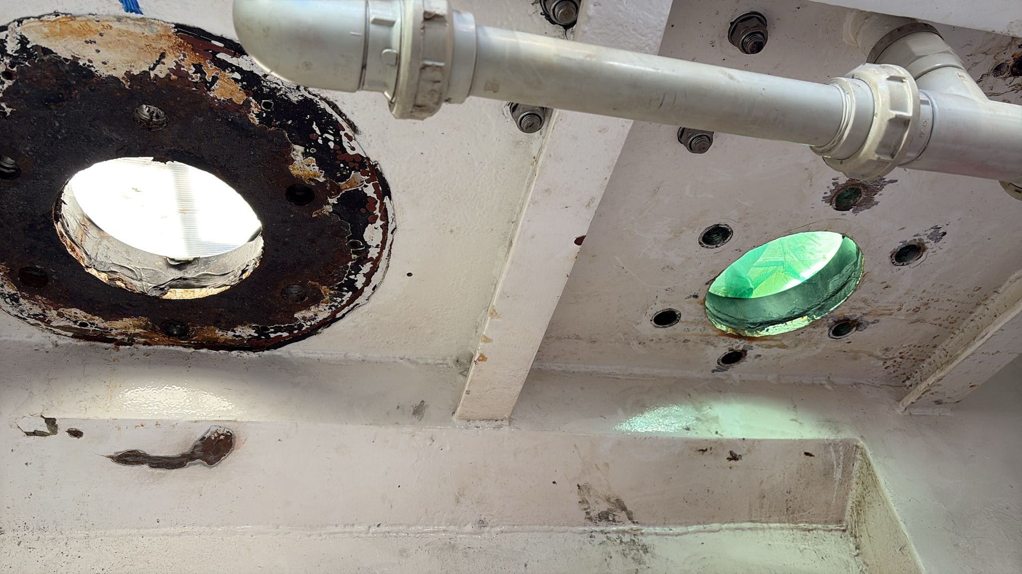 The windlass openings seen from inside the chain locker, corrosion around both