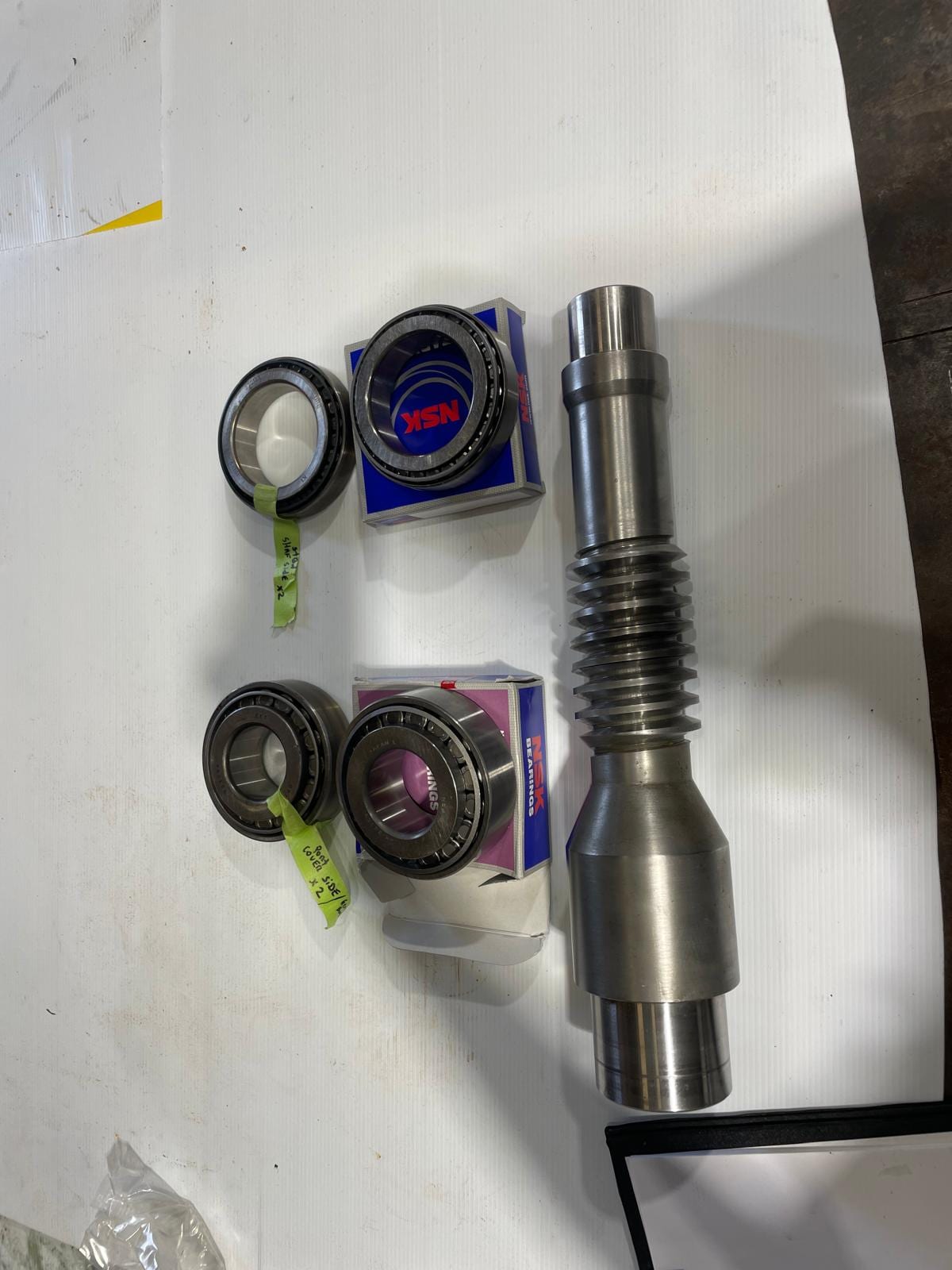 Worm shaft and new taper roller bearings laid out for assembly