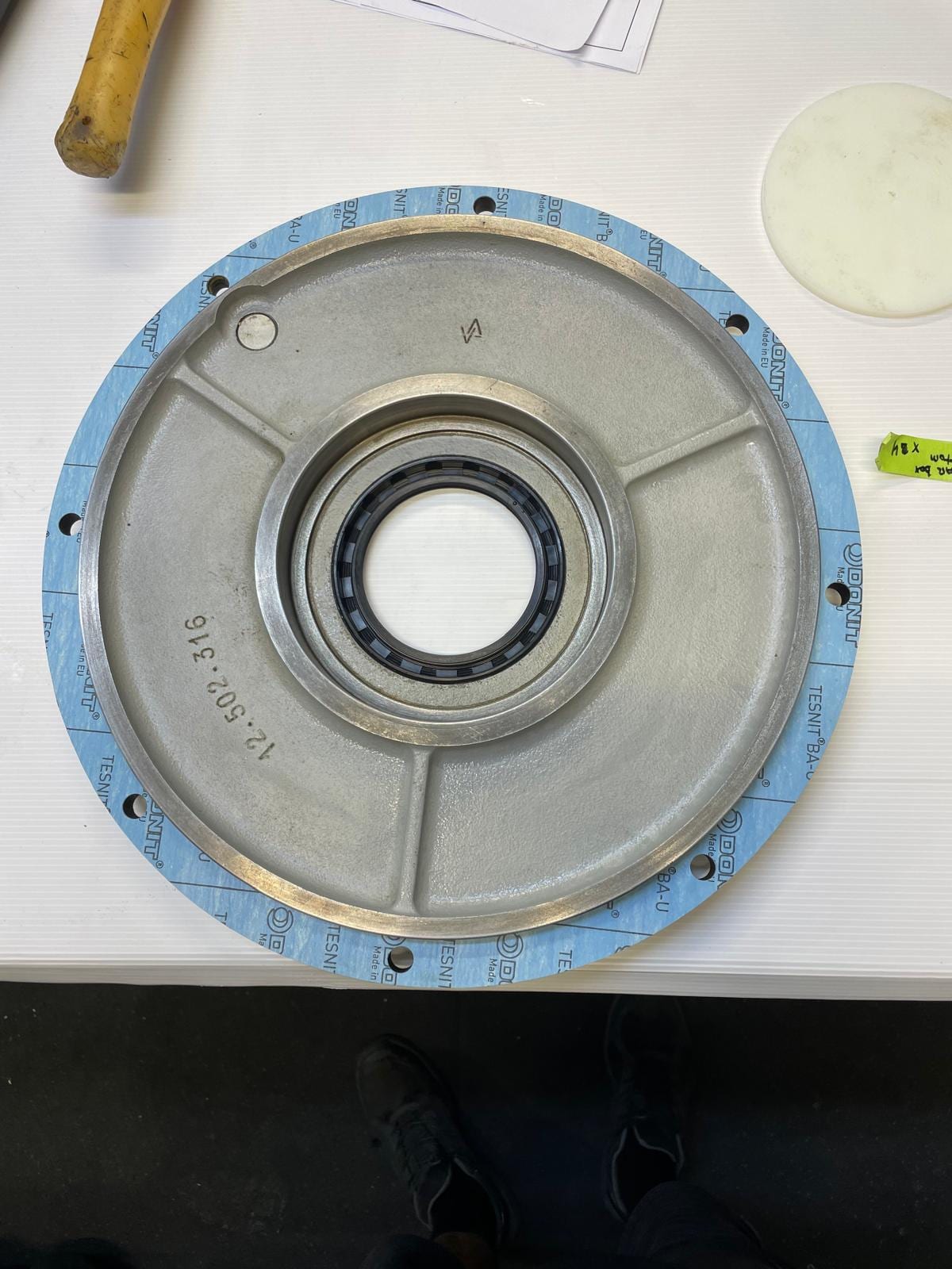 Gearbox cover with its new locally cut gasket and lip seal