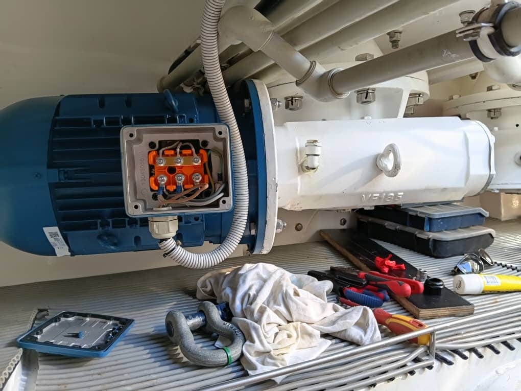 One of the new electric motors coupled to its gearbox and wired by the crew