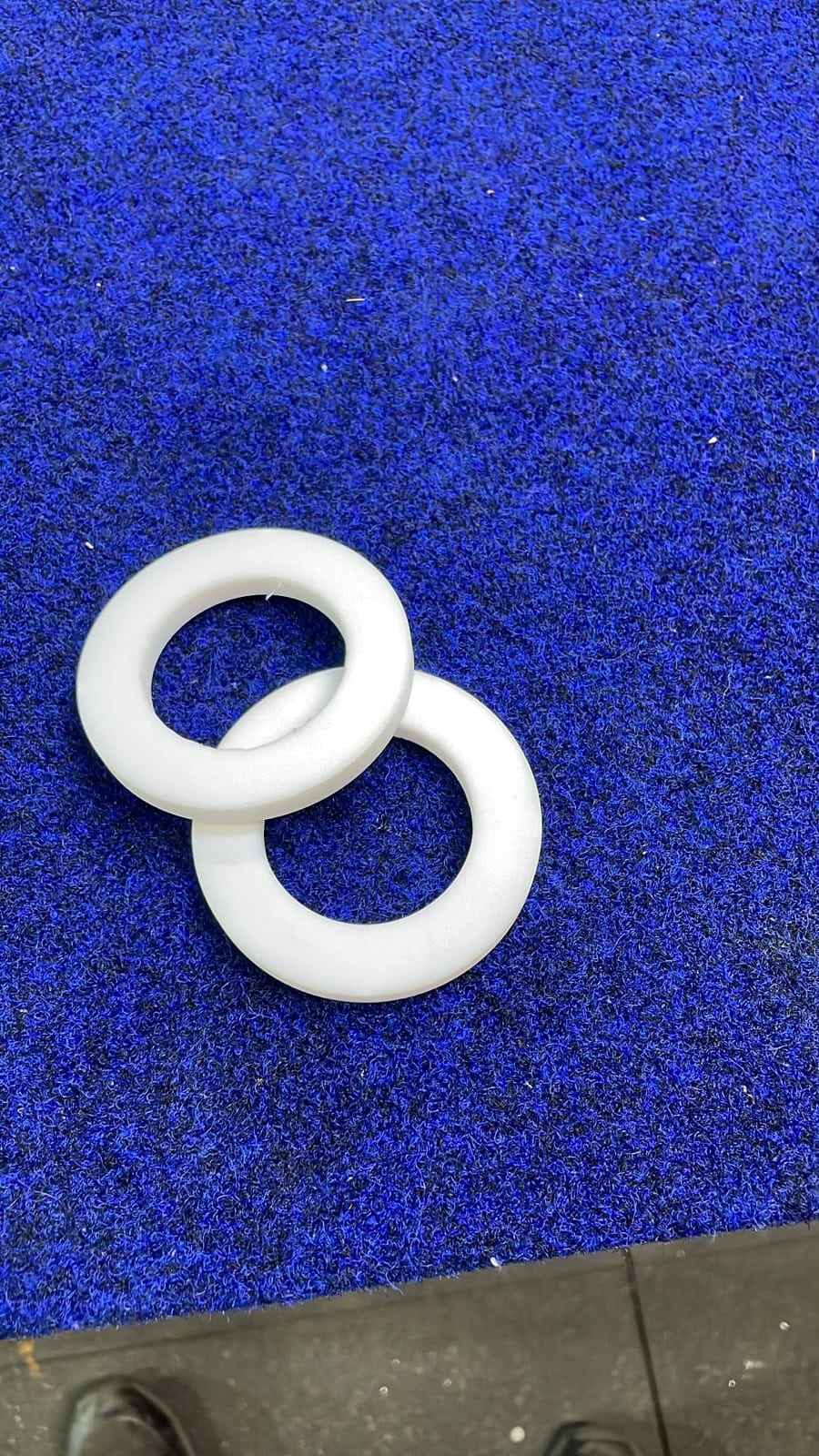 PTFE washers machined from bar stock, posted to the crew with a spare washer kit